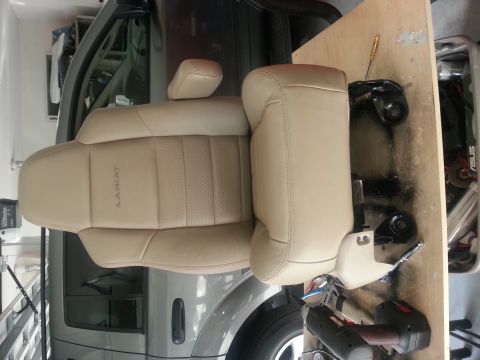 1994 Ford Bronco - Close-up of a tan leather car seat, possibly from a truck, with 'Lariat' branding visible.