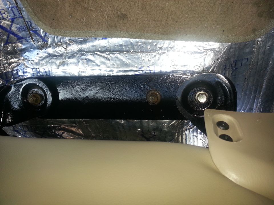 Seat mounting bracket with sound deadening material