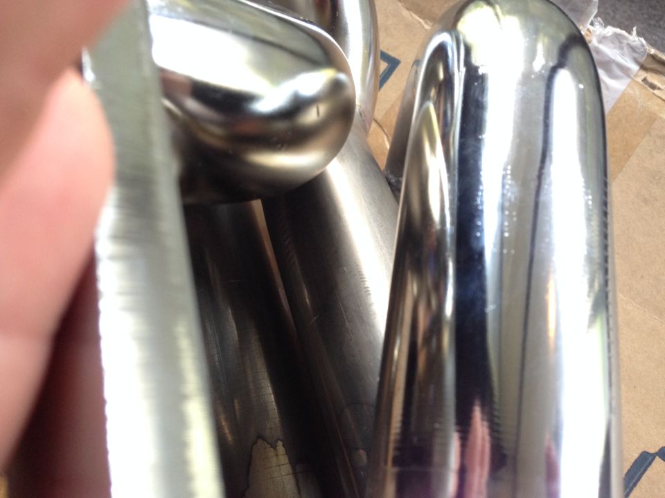These are images that I sent in of the defects for my return. I have chosen to document them here for future use.

Update: I have sent these back in favor of the ceramic ones as I could not accept installing a part that was not fully coated and rusting right out of the box.