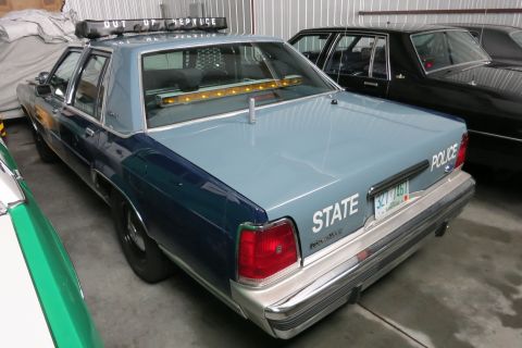 1991 Ford LTD Crown Victoria - Rear view of a 1991 Ford Crown Victoria LTD police car with 'STATE' and 'POLICE' markings.