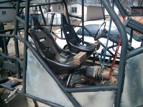 1986 Ford Bronco - Interior view of a custom off-road buggy, bucket seats, a roll cage, and a steering wheel. Text from a watermark is visible.