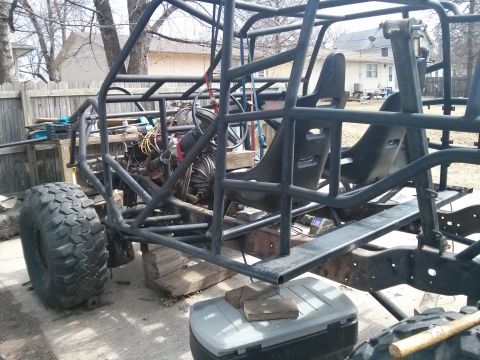 1986 Ford Bronco - Custom off-road buggy frame with racing seats and engine visible, supported by blocks.
