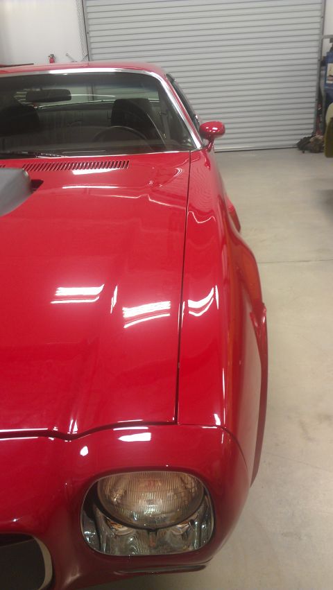 1972 Pontiac Trans Am - Front quarter view of a red 1972 Pontiac Trans Am, showing its distinctive body style and headlight.