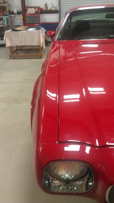 1972 Pontiac Trans Am - Close-up of the front fender and headlight assembly on a red 1972 Pontiac Trans Am.