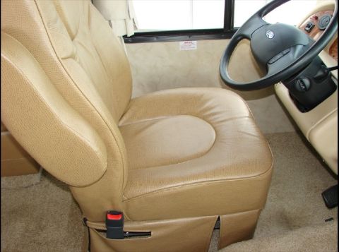 2010 Ford F-450 - Interior view of a tan leather driver's seat and steering wheel in a recreational vehicle.