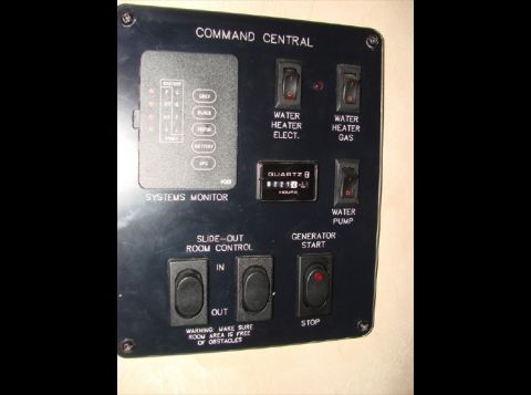 2010 Ford F-450 - RV command central panel displays systems monitor, water heater, water pump, and generator controls.