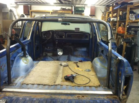 1979 Ford Bronco - Interior view of a 1979 Ford Bronco undergoing modifications with a newly installed roll cage.