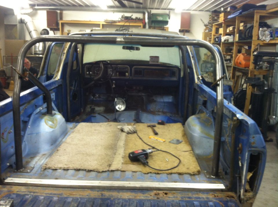 1979 Ford Bronco interior with roll cage installed, showing dashboard and empty cargo area