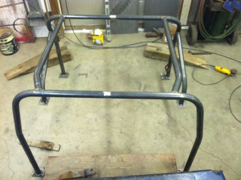 1979 Ford Bronco - A custom-built roll cage is shown assembled in a workshop setting.