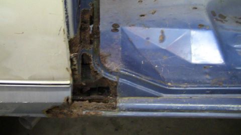 1979 Ford Bronco - The door frame and rocker panel show significant rust damage, indicating a need for repair.