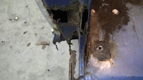 1979 Ford Bronco - Close-up of heavily rusted vehicle frame, indicating significant structural decay.