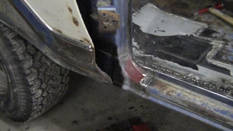 1979 Ford Bronco - Close-up view of a vehicle's door sill area showing rust damage and repair work in progress.