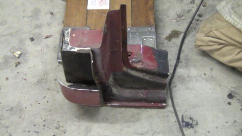 1979 Ford Bronco - A section of a car fender, possibly from a vintage vehicle, is shown in a workshop setting.
