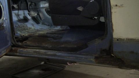 1979 Ford Bronco - The interior of this vehicle shows significant rust on the floorboards and door sills.