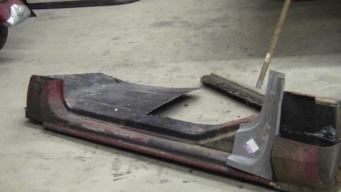 1979 Ford Bronco - Car door sill sections and trim pieces are laid out on a concrete floor.