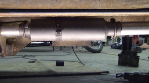 1979 Ford Bronco - Close-up of an exhaust system component, likely a muffler, attached to the undercarriage.