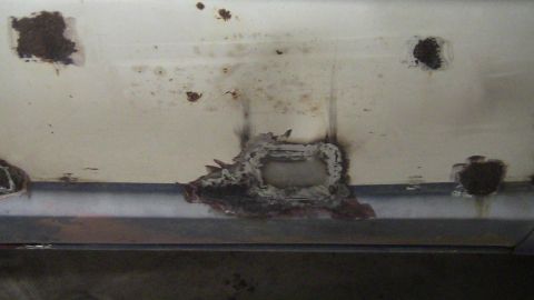 1979 Ford Bronco - Close-up of heavily rusted metal panel, likely a vehicle body part.