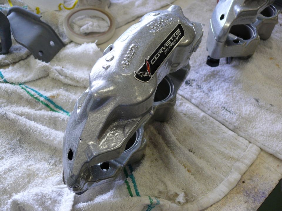 Corvette Stingray brake caliper on a towel, with another caliper in the background