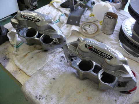 Corvette brake calipers with "CORVETTE STINGRAY" text and emblem, on towels