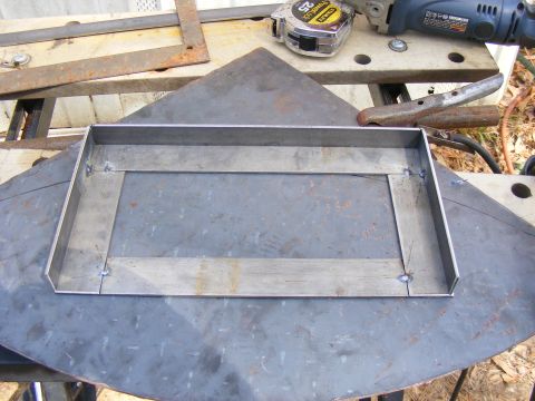 Welded metal frame on a workbench with tools