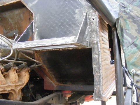 Custom metalwork around engine bay, showing diamond plate and welded seams