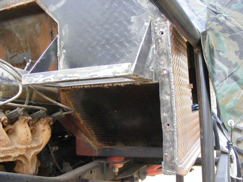 Custom metalwork around engine bay, showing diamond plate and welded seams