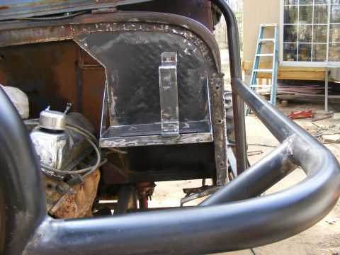 Custom fabricated battery box and roll cage on a vehicle