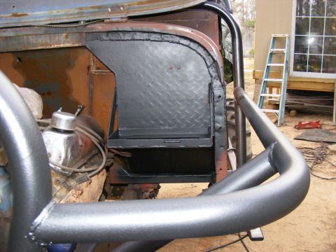 Custom metal box installed in a vehicle's interior, near the engine and roll cage