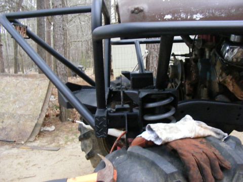 close-up of buggy frame with roll cage, suspension, and tire