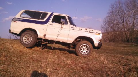 1979 Ford Bronco - This 1979 Ford Bronco is seen on a grassy incline under a clear sky.