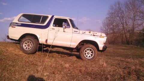 1979 Ford Bronco - This classic Ford Bronco sits on a hill under a clear blue sky.