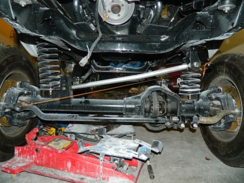 1979 Ford Bronco - Close-up of vehicle suspension and differential components during maintenance or repair.