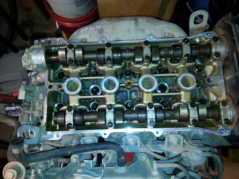 1991 Ford Festiva - Close-up of an engine's cylinder head, revealing the camshafts and valve train components.
