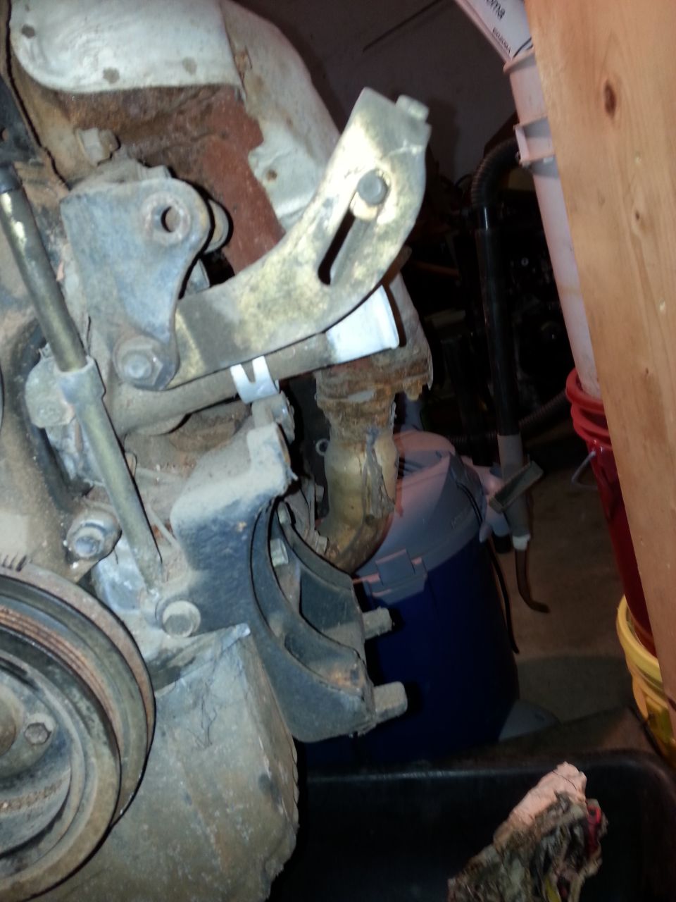 Close-up of rusty engine bracket and pulley system
