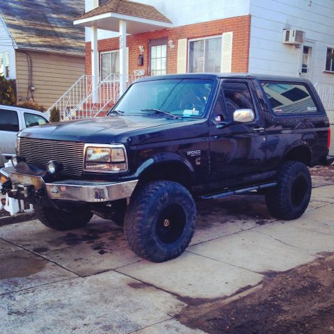 1995 Ford Bronco - This lifted 1995 Ford Bronco features a prominent chrome grille and an aftermarket bumper, giving it a stance.