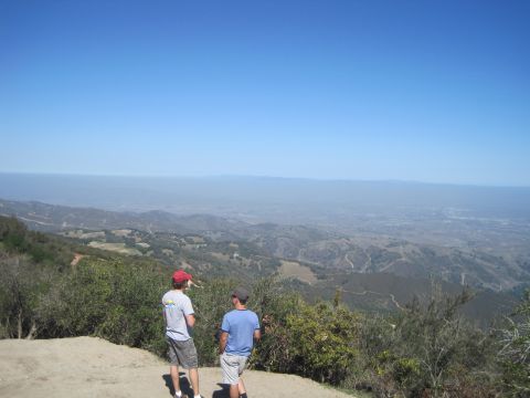 1989 Ford Bronco - Two men observe the expansive, hazy landscape from a high vantage point on a clear day.