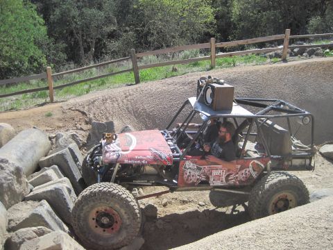1989 Ford Bronco - This heavily modified off-road buggy navigates a rocky obstacle course, a custom roll cage and external speakers.