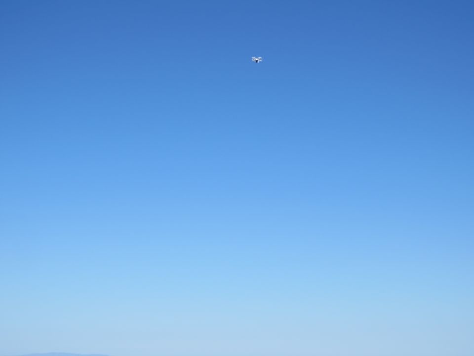 Drone flying in a clear blue sky