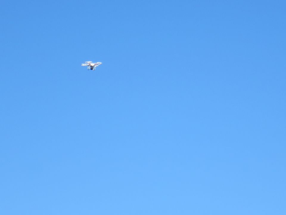drone flying in clear blue sky