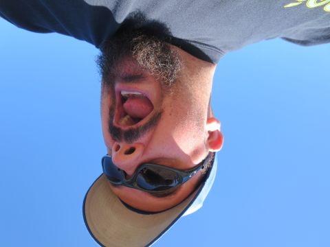 1989 Ford Bronco - Man with beard and sunglasses against a clear blue sky.