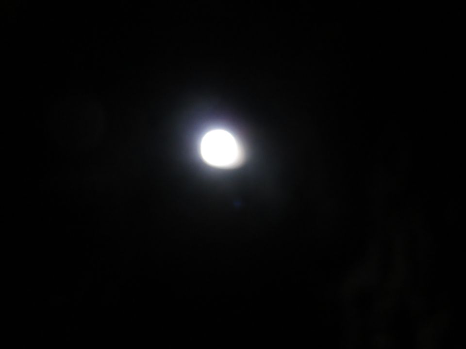 Moon in a dark sky with a bright glow