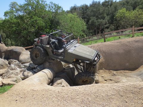 1989 Ford Bronco - This Jeep Wrangler is navigating a challenging obstacle on an off-road course.
