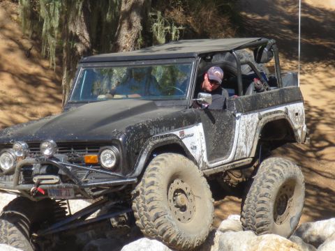 1989 Ford Bronco - This modified Ford Bronco navigates a rocky trail, its off-road capabilities.