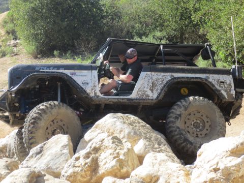 1989 Ford Bronco - This heavily modified Ford Bronco is tackling a challenging rocky trail.