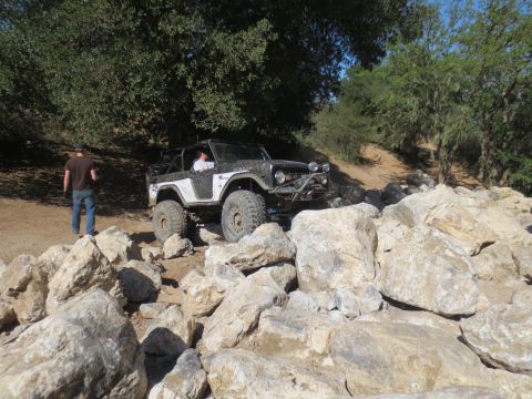 1989 Ford Bronco - This modified Ford Bronco is shown tackling a challenging rocky terrain.