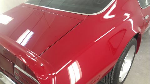 1972 Pontiac Trans Am - Close-up of the rear of a red 1972 Pontiac Trans Am, showing the trunk and fender.