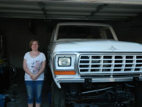 1979 Ford Bronco - A woman stands beside a white Ford Bronco, which appears to be a 1978 model, inside a garage.