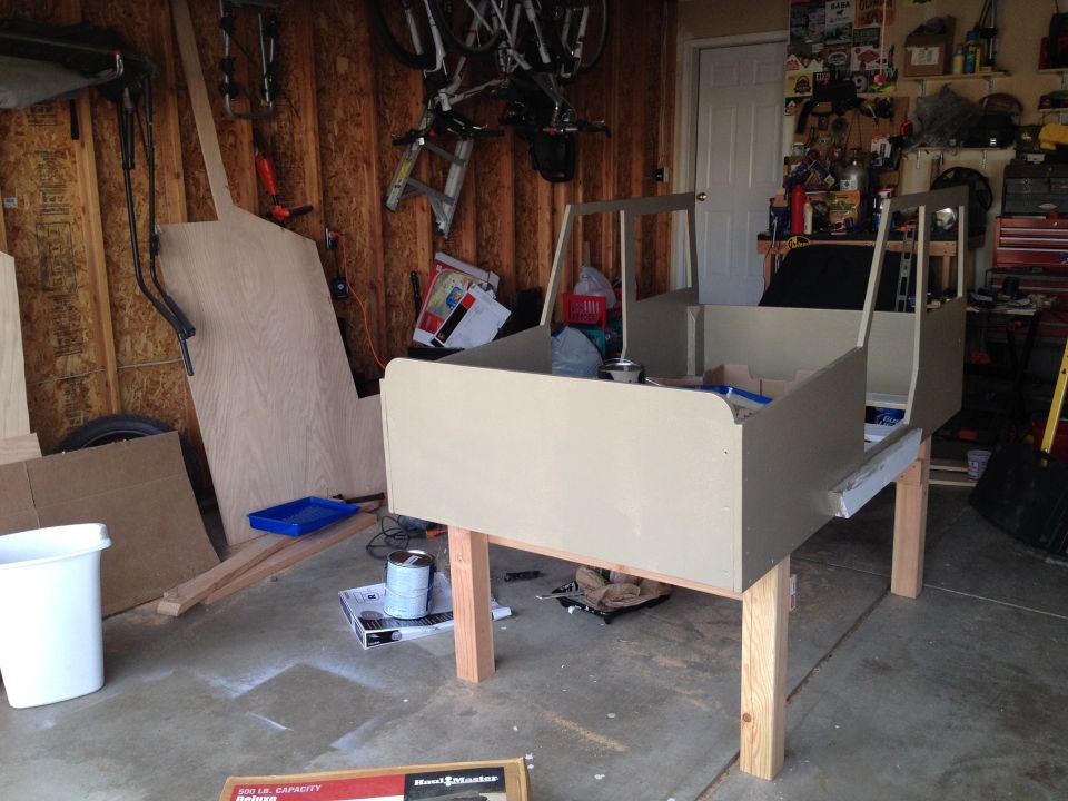 Unfinished vehicle body on sawhorses in a garage