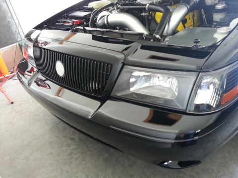 2003 Mercury Marauder - Front view of a black 2003 Mercury Marauder, showing the grille and engine compartment.