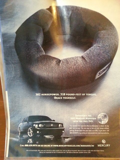 2003 Mercury Marauder - Advertisement for the 2003 Mercury Marauder, highlighting its horsepower and torque, with contact information.